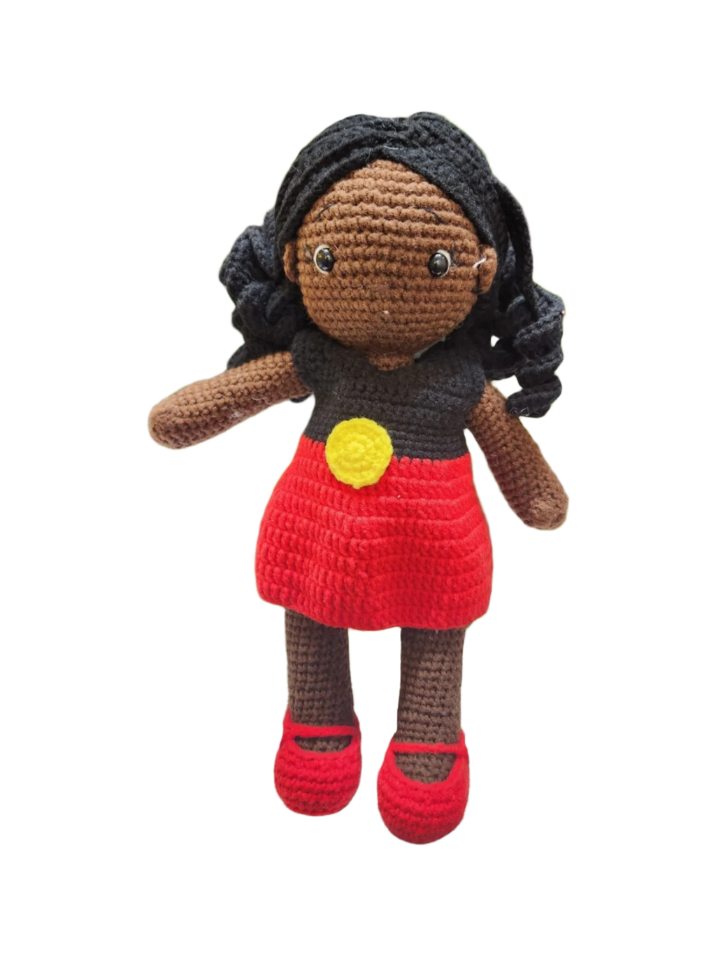 Suzie's Sunshine Dolls Alinta, a crochet doll with black curly hair, wearing a red dress and black top inspired by the Aboriginal flag.