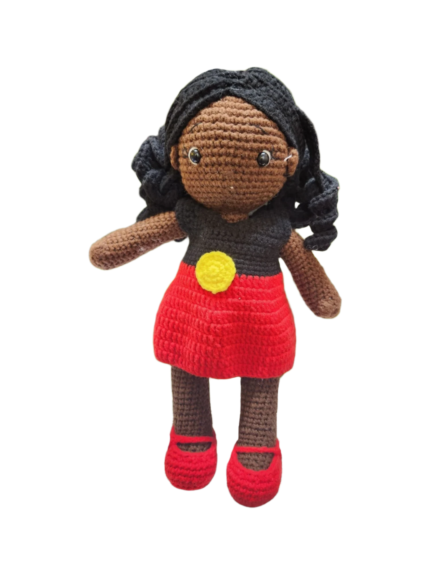 Suzie's Sunshine Dolls Alinta, a crochet doll with black curly hair, wearing a red dress and black top inspired by the Aboriginal flag.