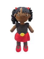 Suzie's Sunshine Dolls Alinta, a hand-crocheted doll with black curly hair, wearing a black top and red skirt with yellow detail, inspired by the Aboriginal flag.