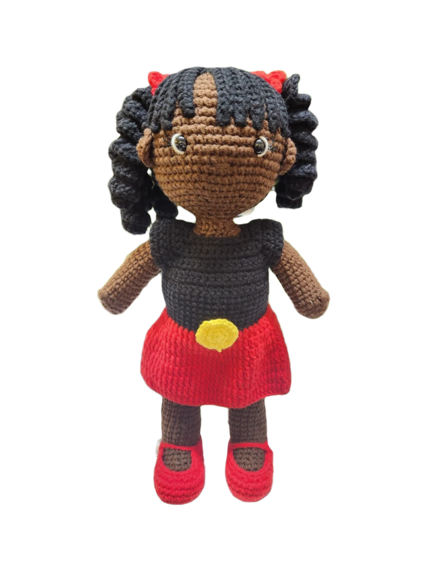Suzie's Sunshine Dolls Alinta, a hand-crocheted doll with black curly hair, wearing a black top and red skirt with yellow detail, inspired by the Aboriginal flag.