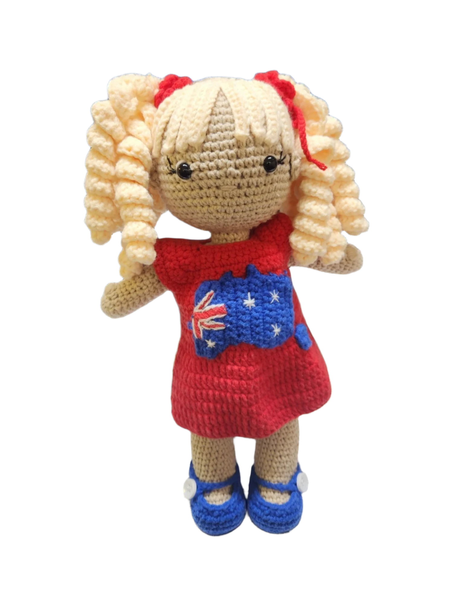 Suzie's Sunshine Dolls Mia, a crocheted doll with long blonde curly hair, wearing a red dress with the Australian flag and map appliqué, and blue shoes.