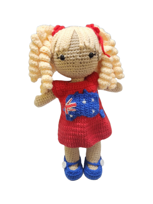 Suzie's Sunshine Dolls Mia, a crocheted doll with long blonde curly hair, wearing a red dress with the Australian flag and map appliqué, and blue shoes.