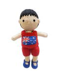 Suzie's Sunshine Dolls Jack, a crocheted doll with short black hair, wearing a red outfit with the Australian flag on the chest and blue shoes.