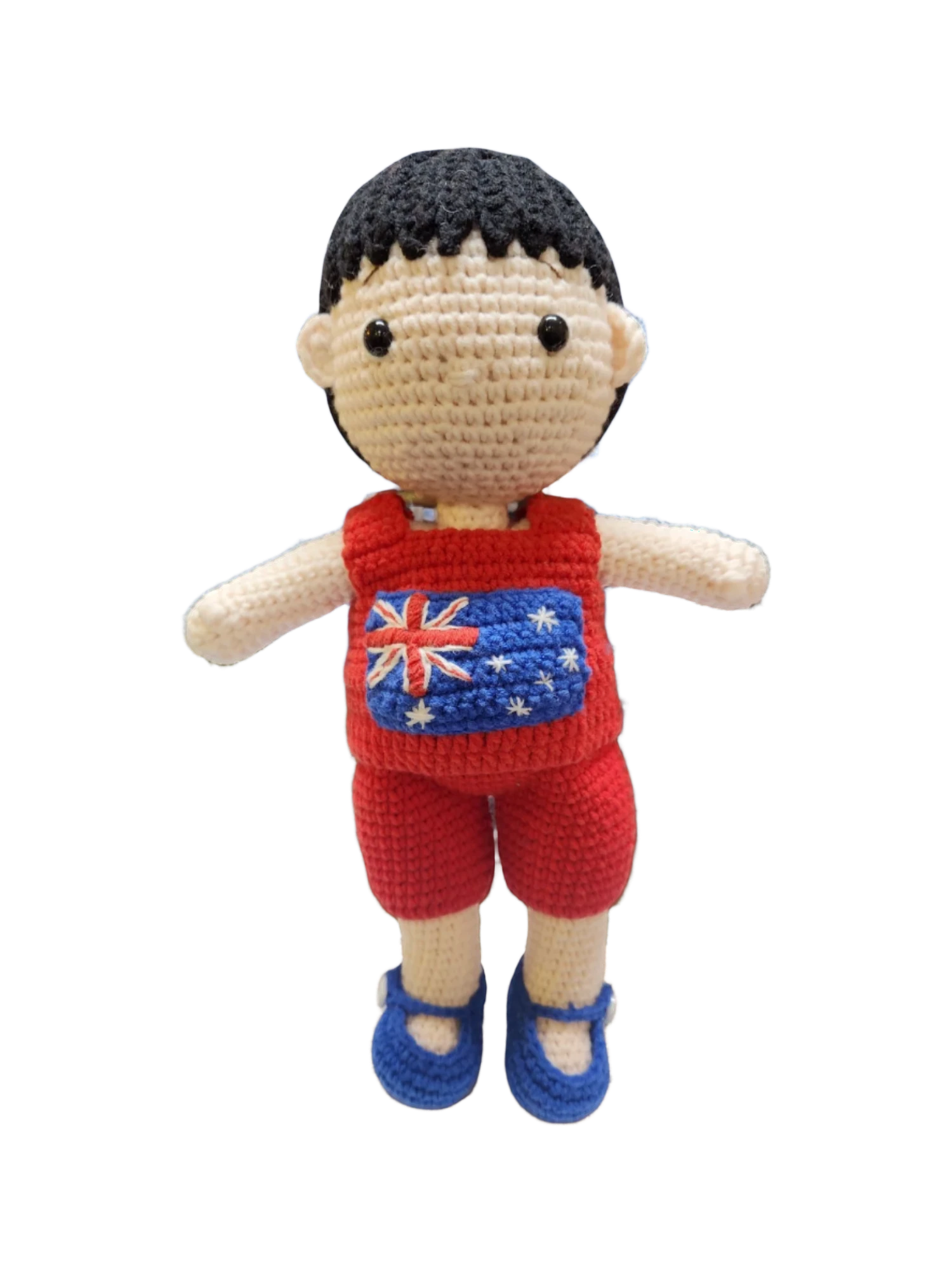 Suzie's Sunshine Dolls Jack, a crocheted doll with short black hair, wearing a red outfit with the Australian flag on the chest and blue shoes.