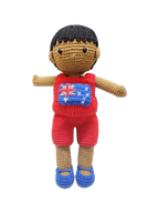 Suzie's Sunshine Dolls Jack, a crocheted doll with short black hair, wearing a red outfit with the Australian flag on the chest and blue shoes.