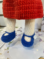 Suzie's Sunshine Dolls Mia, a crocheted doll with long hair, wearing a red dress and blue shoes with white buttons. Features Australian flag details.