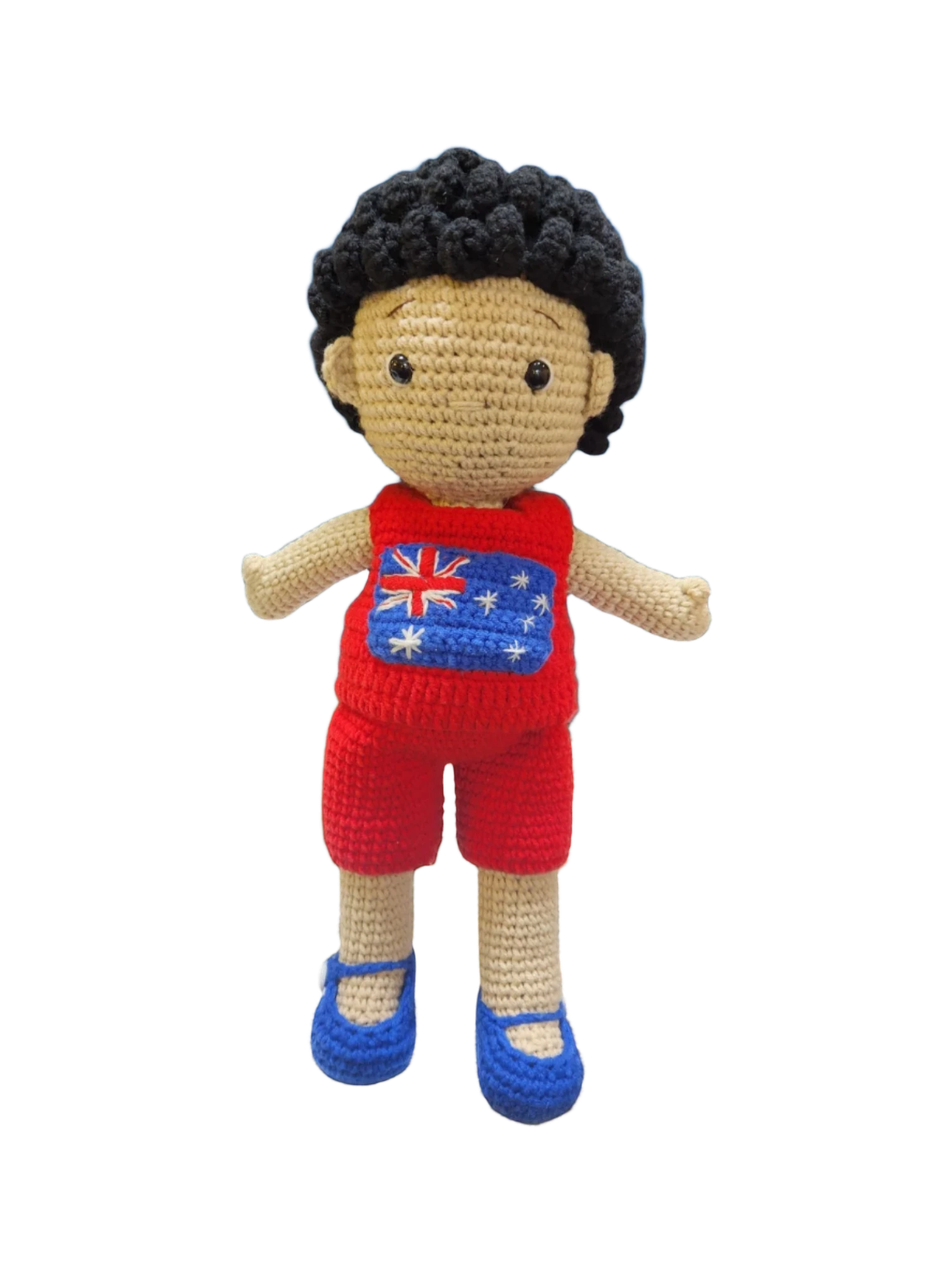 Suzie's Sunshine Dolls Jack, a crocheted doll with short black hair, wearing a red outfit with the Australian flag on the chest and blue shoes.