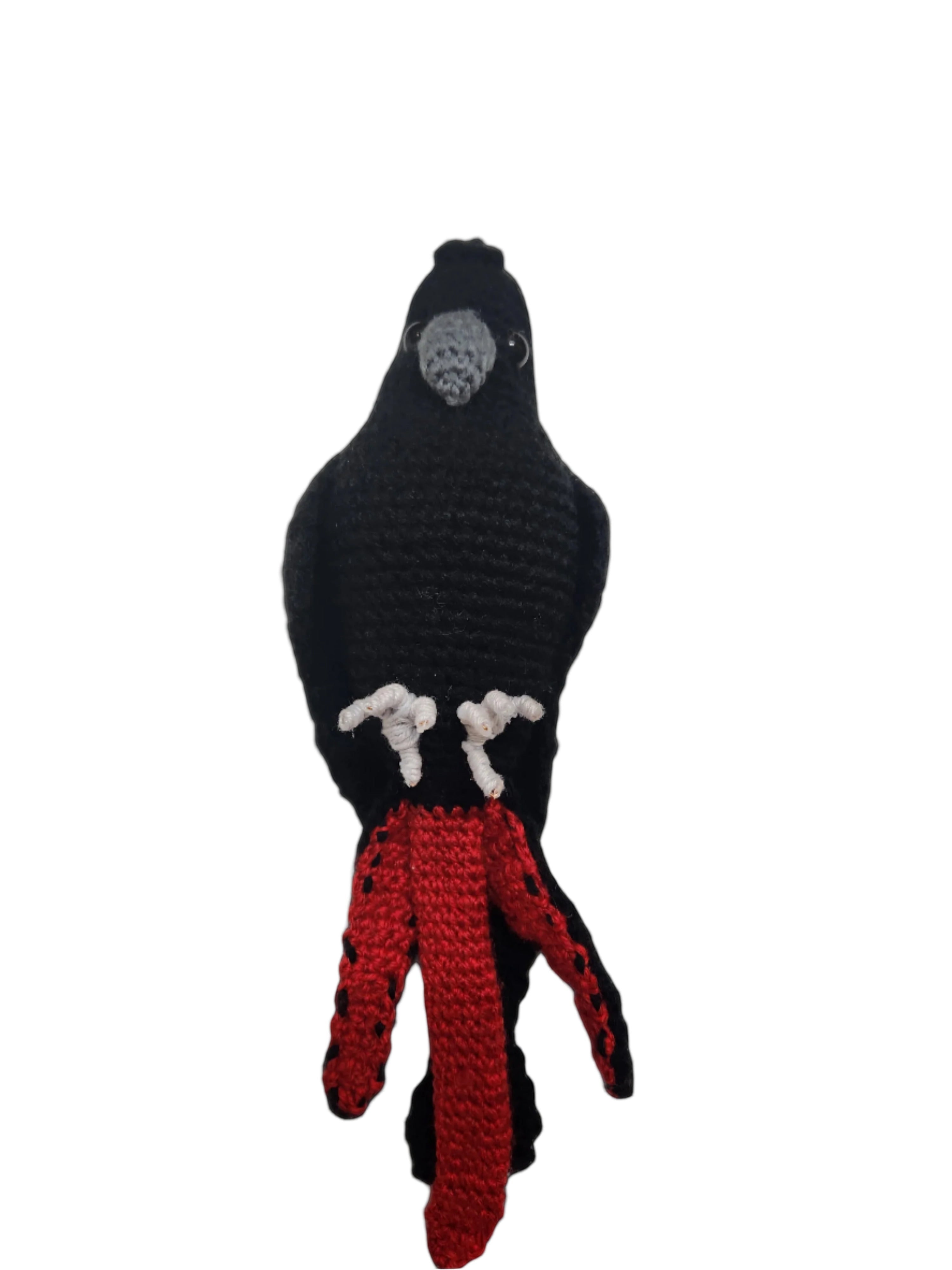 Suzie's Sunshine Dolls black cockatoo crocheted bird with red tail feathers and wire feet.