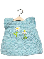 Suzie's Sunshine Dolls light blue crochet doll dress with white daisy embroidery and green stems, handmade with soft yarn.