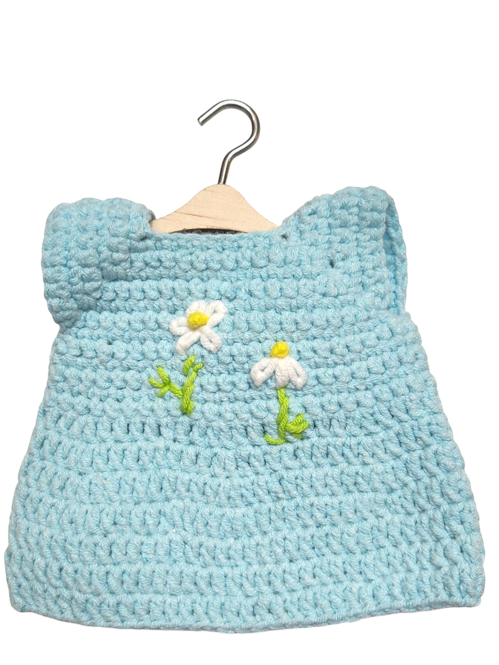 Suzie's Sunshine Dolls light blue crochet doll dress with white daisy embroidery and green stems, handmade with soft yarn.