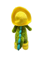 Suzie's Sunshine Dolls Cameron the Croc plush toy wearing a yellow bucket hat and boots, green body with blue accents.