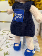 Suzie's Sunshine Dolls navy crocheted doll with Cancer Council NT patch and blue shoes. Yarn doll.