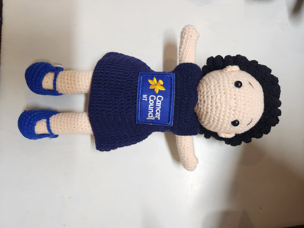 Suzie's Sunshine Dolls hand-crocheted navy doll with Cancer Council NT patch and blue shoes.