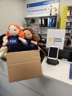 Suzie's Sunshine Dolls hand-crocheted navy dolls with Cancer Council NT patch, symbolic and educational toys.