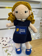 Suzie's Sunshine Dolls navy crocheted doll with blonde curly hair and Cancer Council NT patch. Educational toy.
