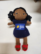 Suzie's Sunshine Dolls navy crocheted doll with Cancer Council NT patch and red shoes. Hand-made yarn toy.
