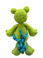 Suzie's Sunshine Dolls Cassius the Croc, a handmade green yarn stuffed toy with blue accents and round ears.