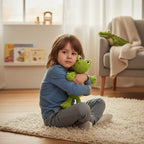 Suzie's Sunshine Dolls Cassius the Croc, a handmade green yarn stuffed toy, held by a child.