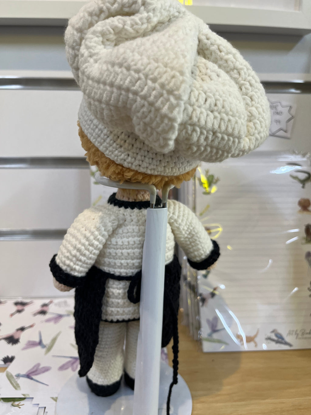 Suzie's Sunshine Dolls handcrafted crochet chef doll in white uniform, black apron, and tall hat. Eco-friendly yarn.