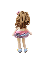 Suzie's Sunshine Dolls Cleo, a handmade crochet doll with brown curly hair, a pink, purple, and blue ruffled dress, and blue shoes.