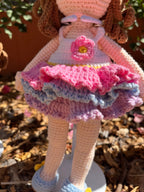Suzie's Sunshine Dolls Cleo ballerina doll with brown yarn curls, pink, purple, blue ruffled dress, and flower applique.
