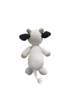 Suzie's Sunshine Dolls Daisy the Cow, a handmade crochet toy with white body, black ears, and tan accents. Perfect for play.