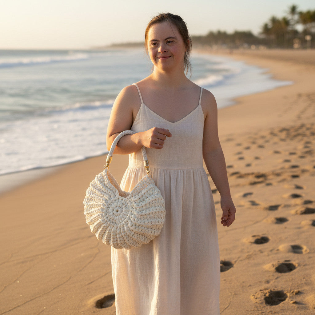 Suzie's Sunshine Dolls cream crochet shell-shaped handbag with braided white leather strap and gold hardware.