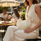 Suzie's Sunshine Dolls cream crochet shell-shaped bag with braided white leather strap and gold hardware.