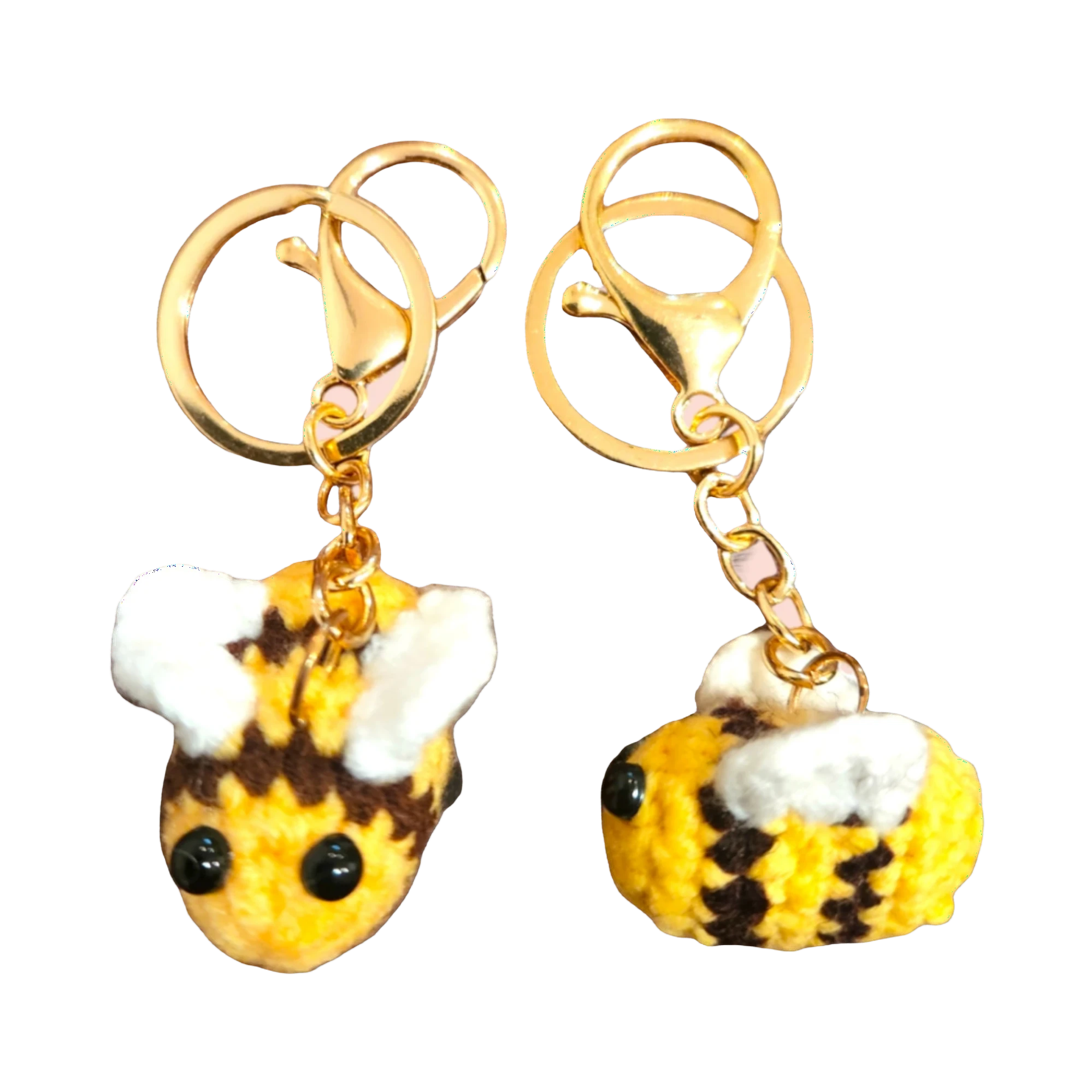 Suzie's Sunshine Dolls handmade crochet bee keychains in yellow, brown, and white yarn with gold clasps.