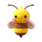 Suzie's Sunshine Dolls handmade yellow and brown crochet bee keychain with pink cheeks and white wings.