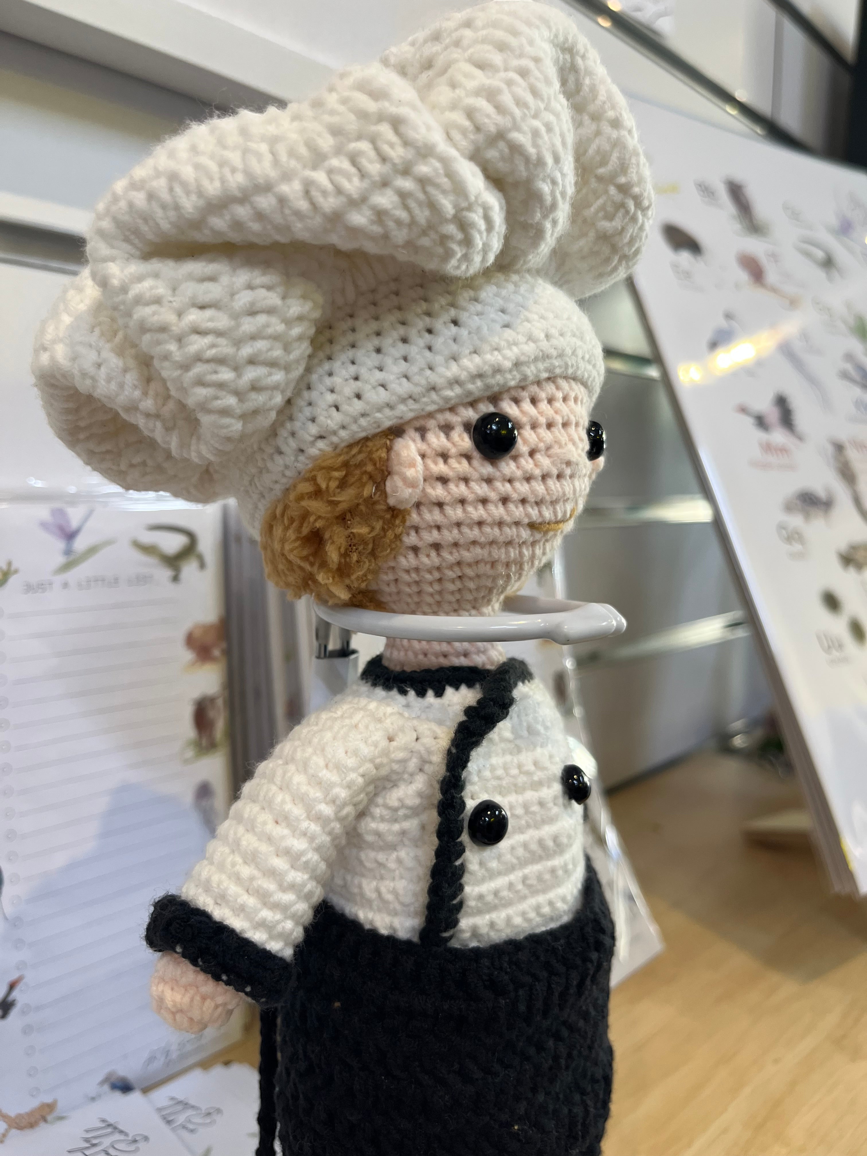 Suzie's Sunshine Dolls handcrafted crochet chef doll in white hat and uniform with black apron and suspenders.