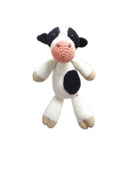 Suzie's Sunshine Dolls Daisy the Cow, a handmade crochet toy with black and white spots, pink snout, and beige hooves.