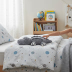 Suzie's Sunshine Dolls Kurtis the Croc, a soft grey crocheted crocodile plush toy with white toes and stitched smile.