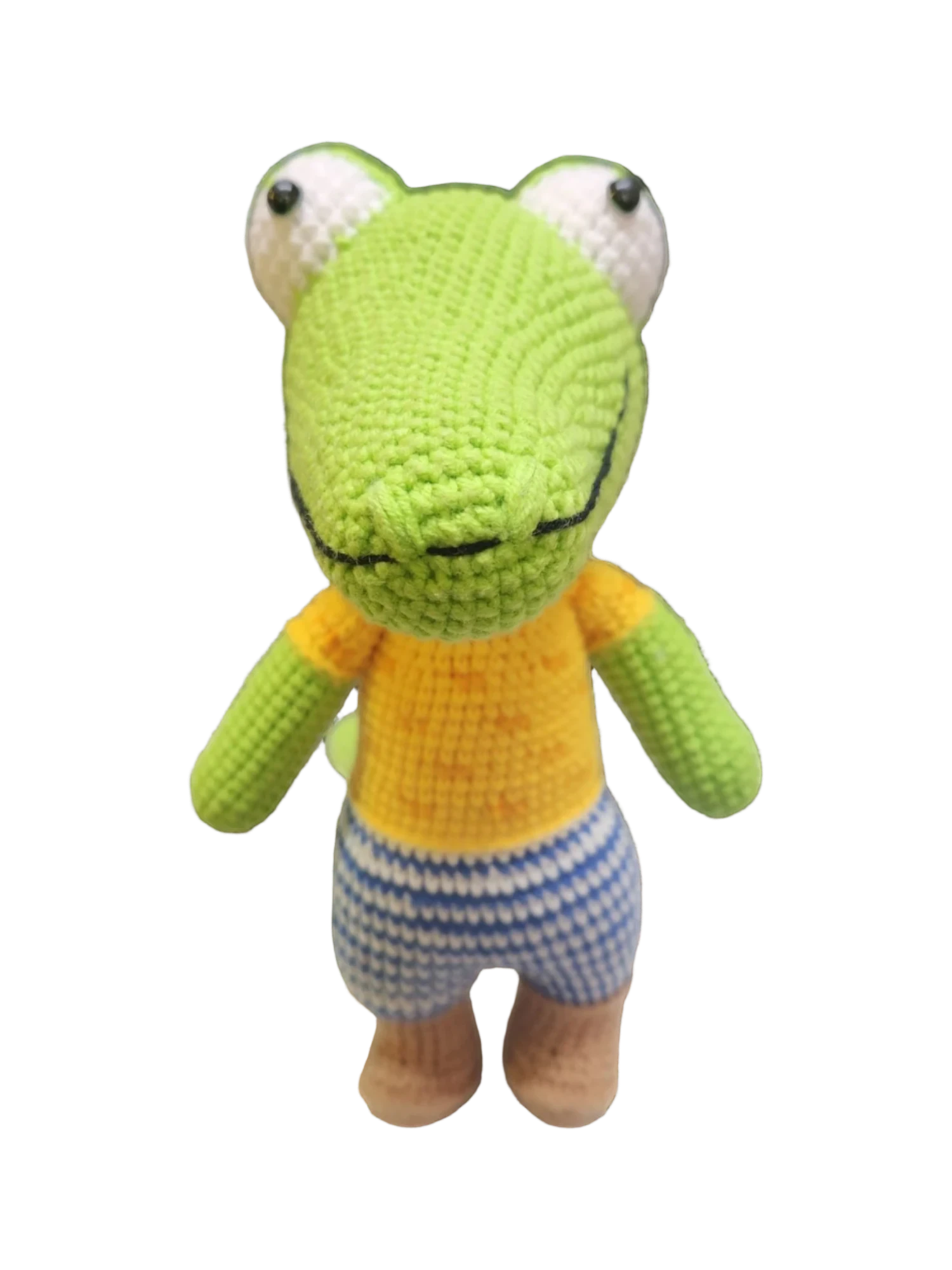Suzie's Sunshine Dolls Calvin the Croc, a handmade crochet toy with a green body, orange shirt, and blue striped shorts.