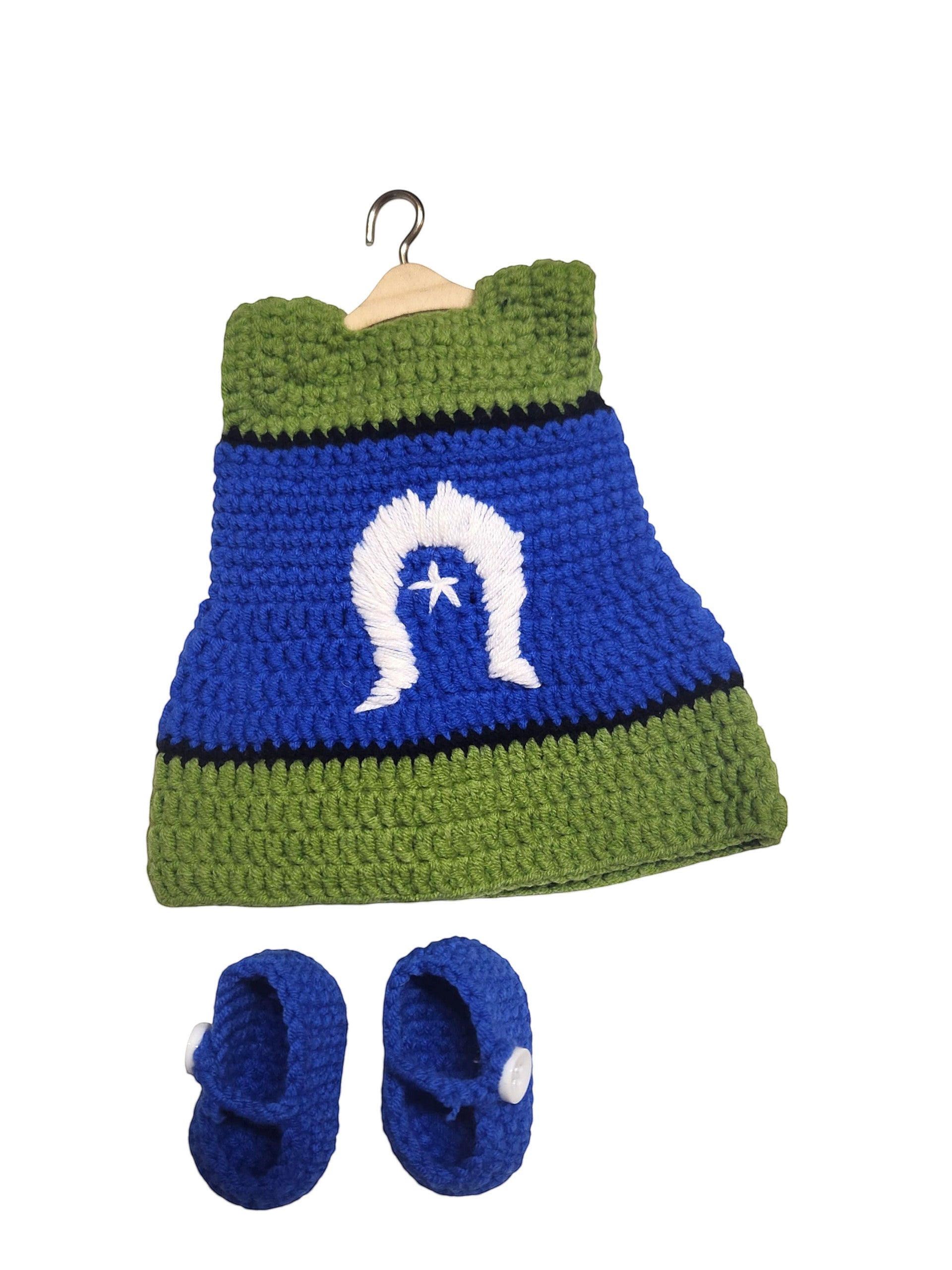 Suzie's Sunshine Dolls handmade crochet doll dress and shoes set in blue, green, and white with a star emblem.