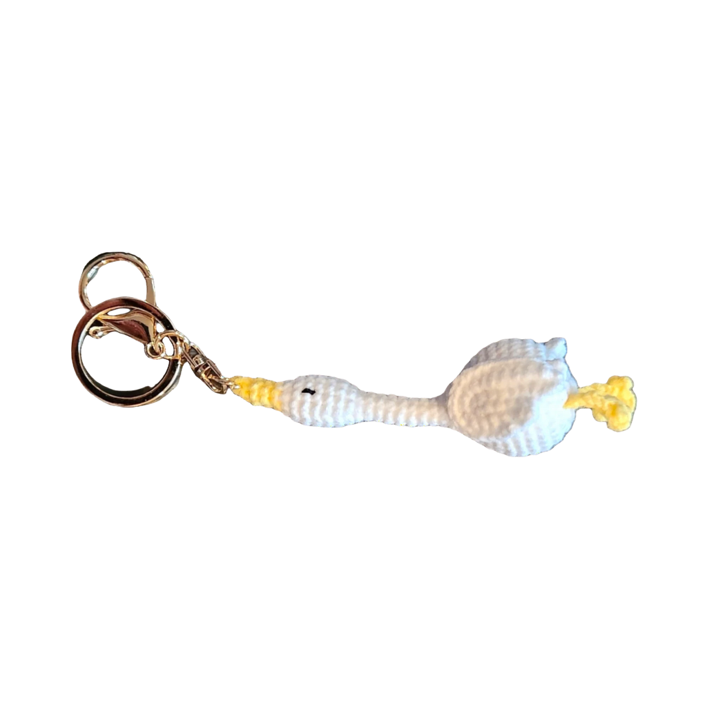 Suzie's Sunshine Dolls white crochet goose keychain with yellow beak and feet, attached to a gold keyring.