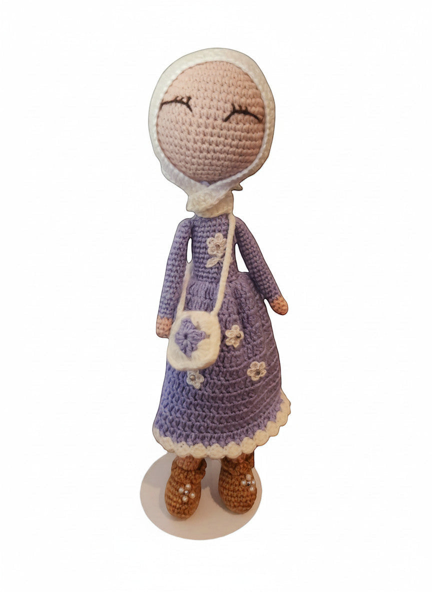 Suzie's Sunshine Dolls handmade crochet doll in lavender dress with white hijab and purse, adorned with flowers.