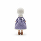Suzie's Sunshine Dolls handmade crochet doll in a purple dress and white hijab, with brown shoes.