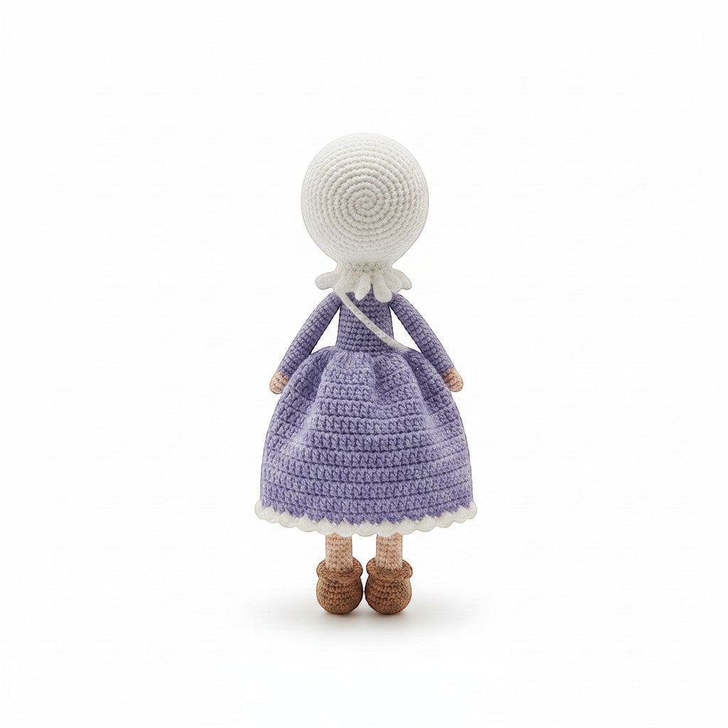Suzie's Sunshine Dolls handmade crochet doll in a purple dress and white hijab, with brown shoes.