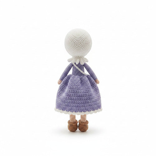 Suzie's Sunshine Dolls handmade crochet doll in a purple dress and white hijab, with brown shoes.
