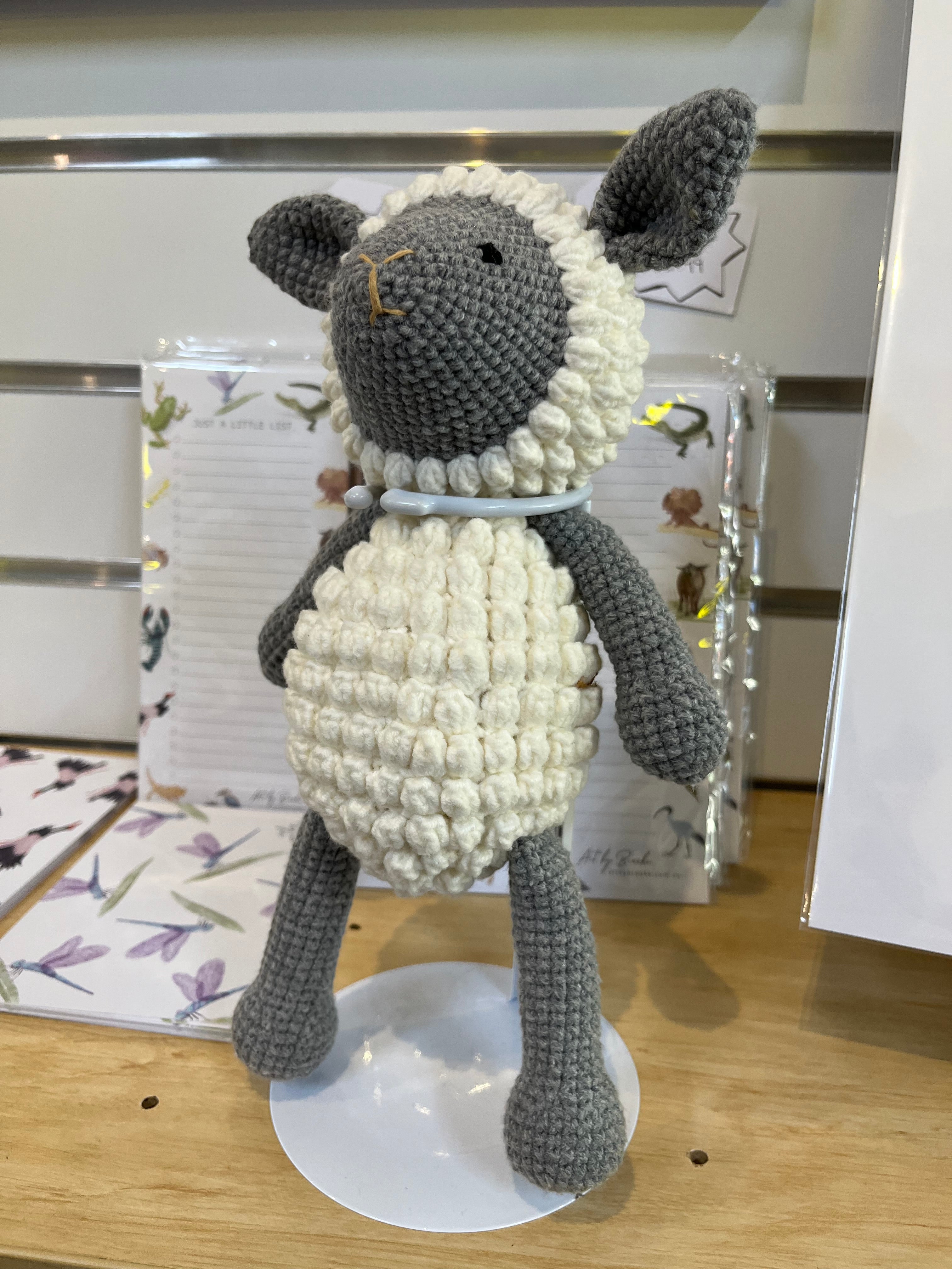 Suzie's Sunshine Dolls handmade grey and cream crochet lamb with bobble-stitched belly and grey face.
