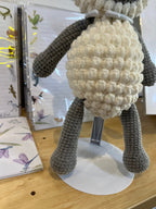 Suzie's Sunshine Dolls handmade crochet lamb toy with cream bobble belly and grey limbs, perfect for nursery decor.