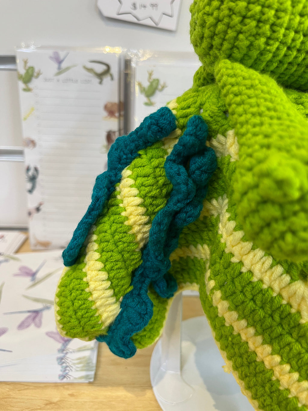 Suzie's Sunshine Dolls Kasabian the Croc lovey blanket, green and cream striped crochet with teal accents.