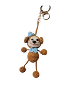 Suzie's Sunshine Dolls handmade brown crochet monkey keychain with blue bow and keyring.