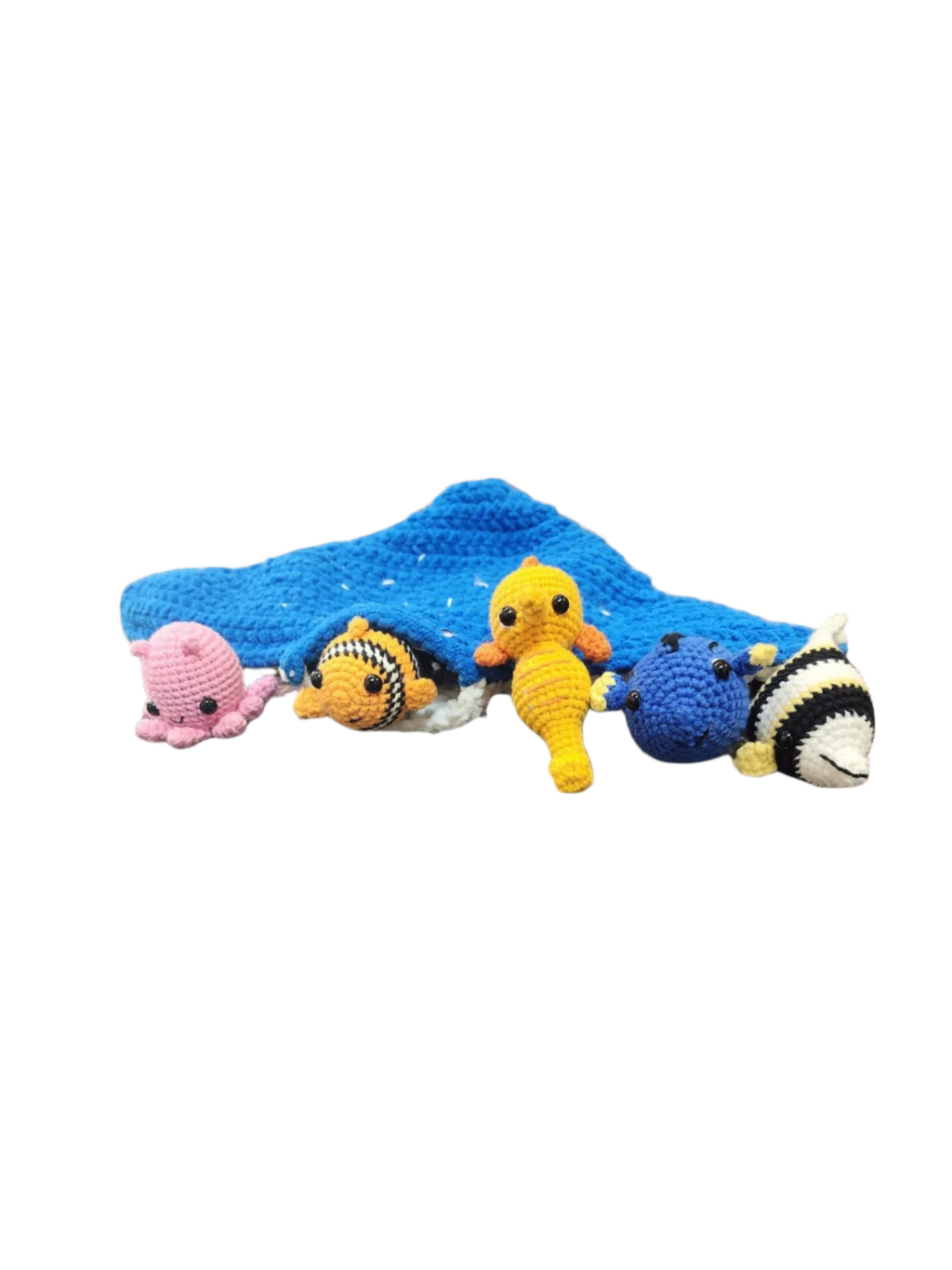 Suzie's Sunshine Dolls crochet manta ray with Nemo clownfish, pink octopus, yellow seahorse, blue tang, and striped fish.