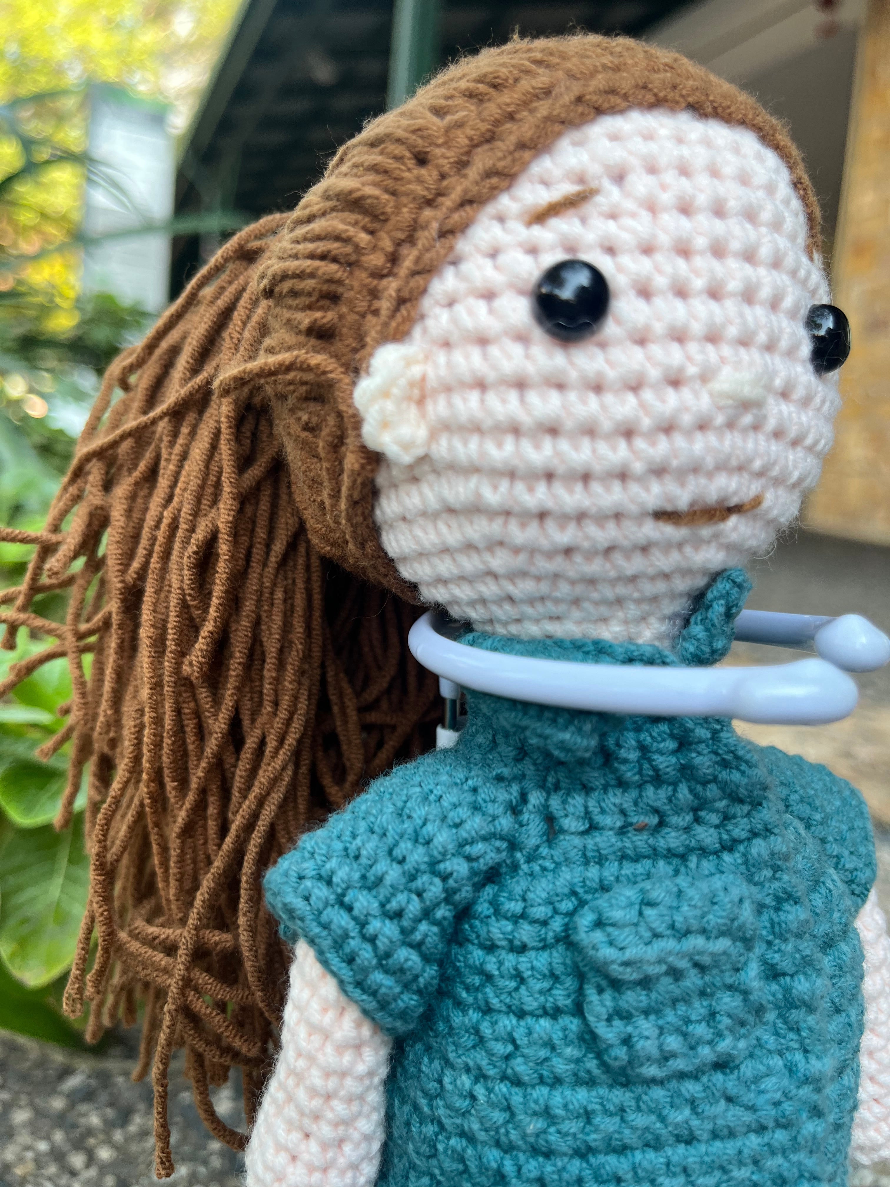 Suzie's Sunshine Dolls crochet paramedic doll in teal uniform with brown yarn hair. Handmade in Australia.