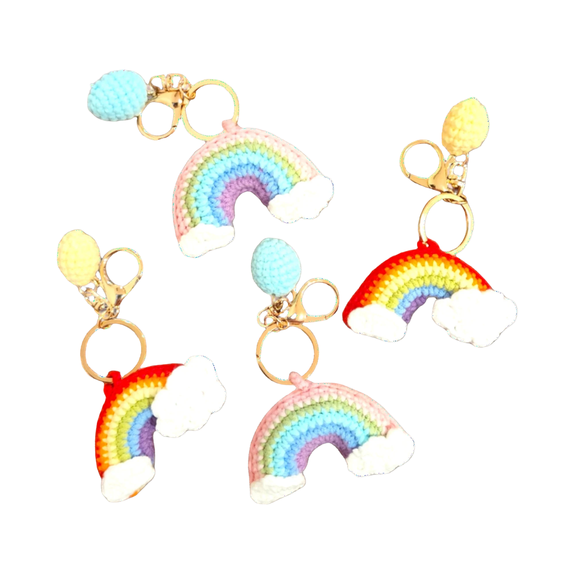 Suzie's Sunshine Dolls handmade crochet rainbow keychains with clouds, in pink, blue, yellow, and red colorways.