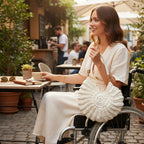 Suzie's Sunshine Dolls off-white crochet shell-shaped bag with braided leather strap and gold hardware.