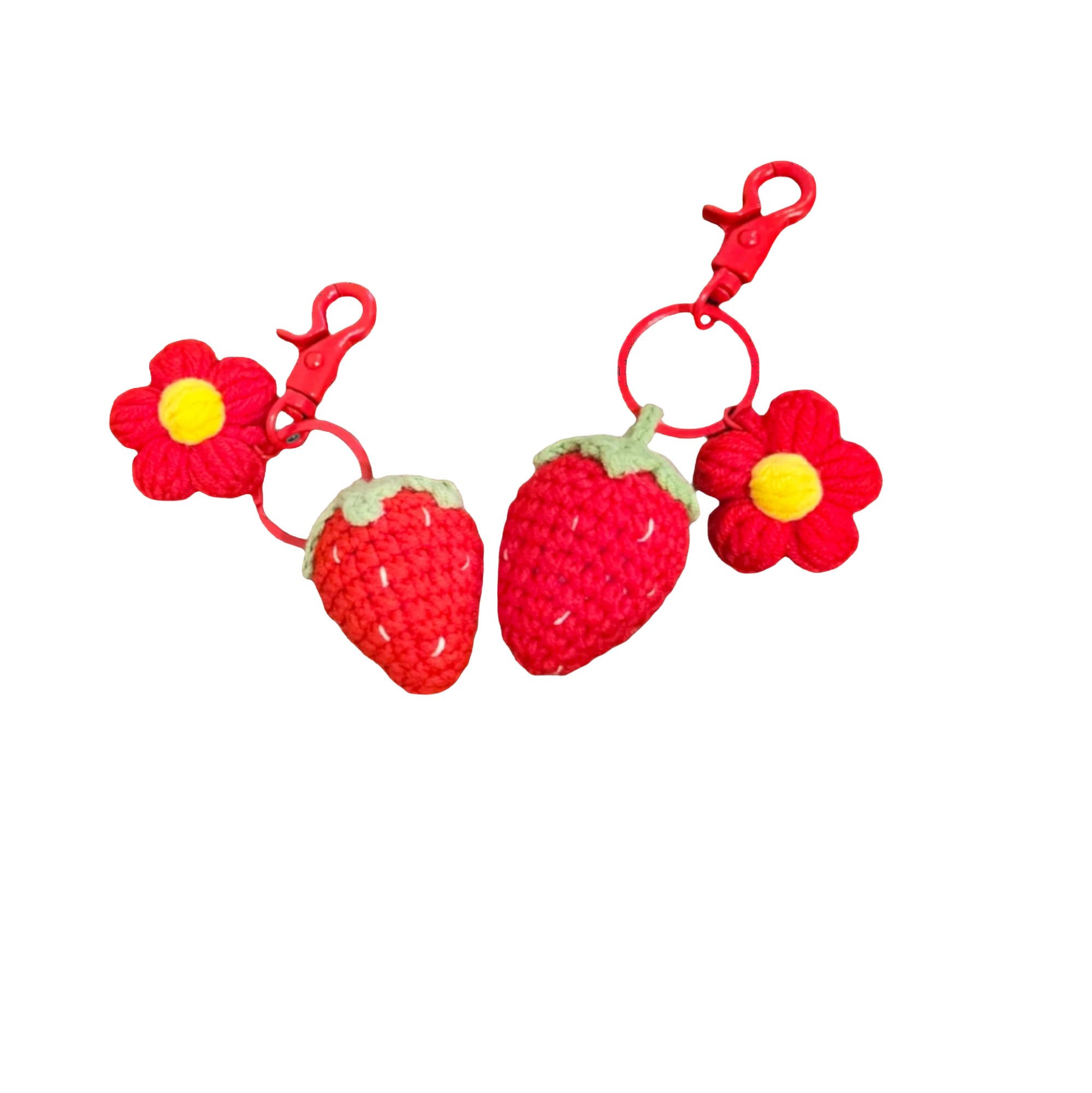 Suzie's Sunshine Dolls handmade crochet strawberry and flower keychains, red yarn with green leaves and yellow center.