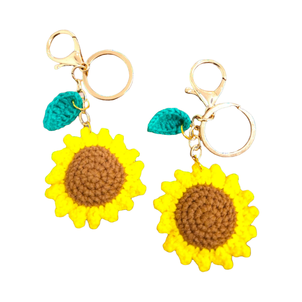 Suzie's Sunshine Dolls handmade crochet sunflower keychains with brown centers and yellow petals, featuring green leaves and gold clasps.